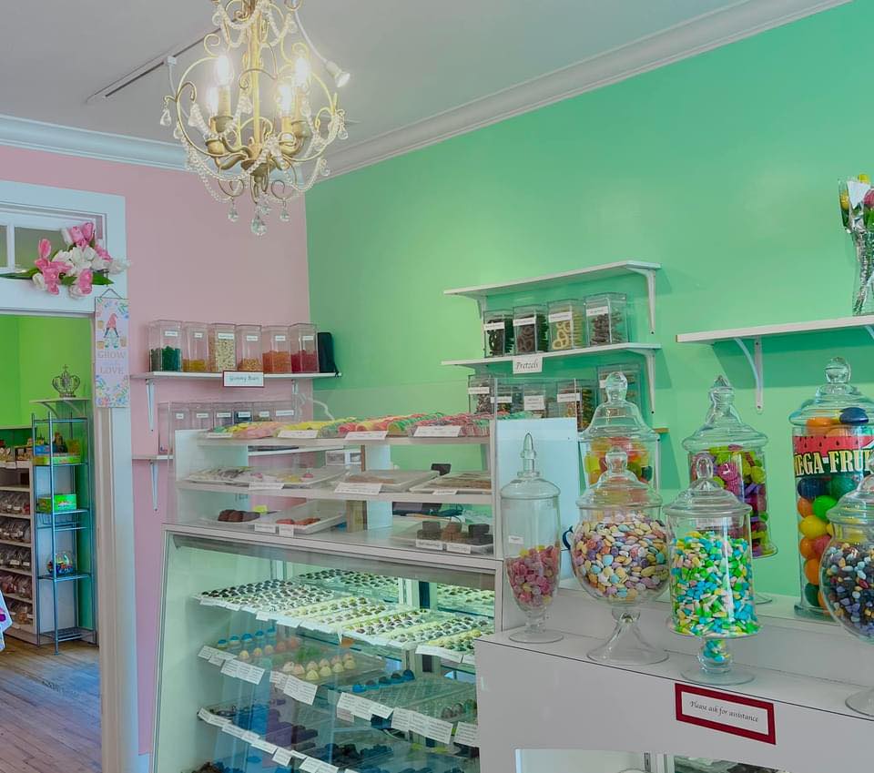 Colorful candy shop interior featuring assorted candies in jars and displays.