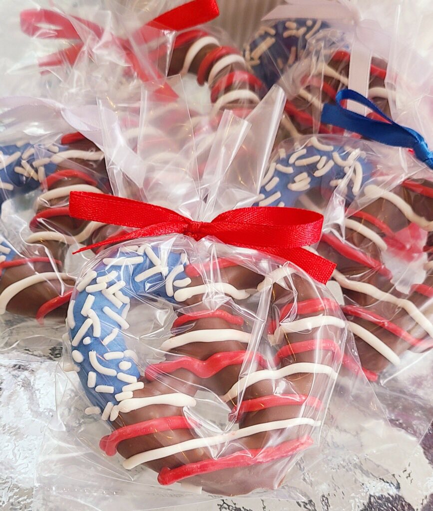 Chocolate candy canes decorated with red, white, and blue frosting