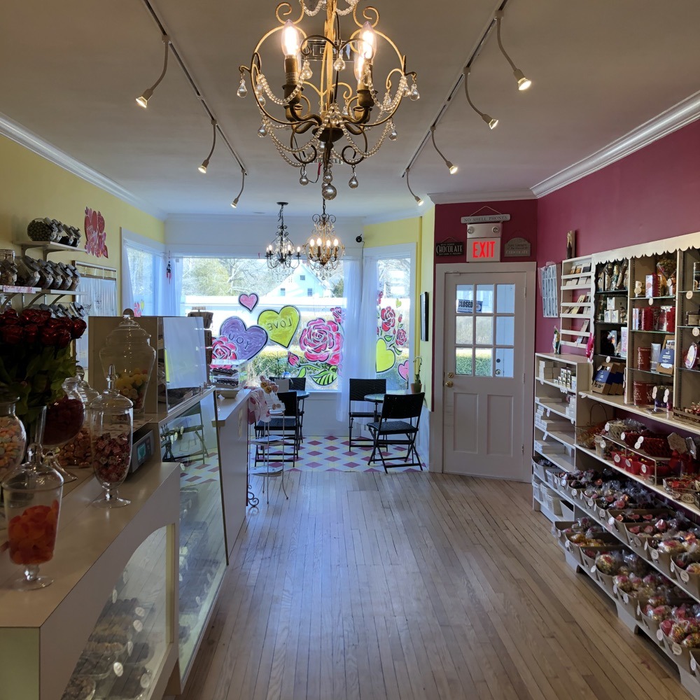 Bright candy shop interior features a cheerful decor with a chandelier